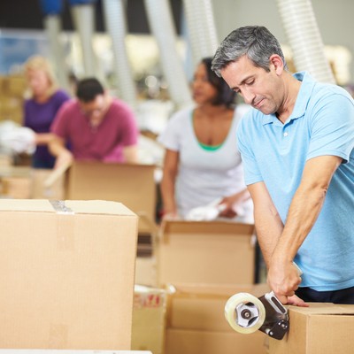 Worker packing orders in warehouse